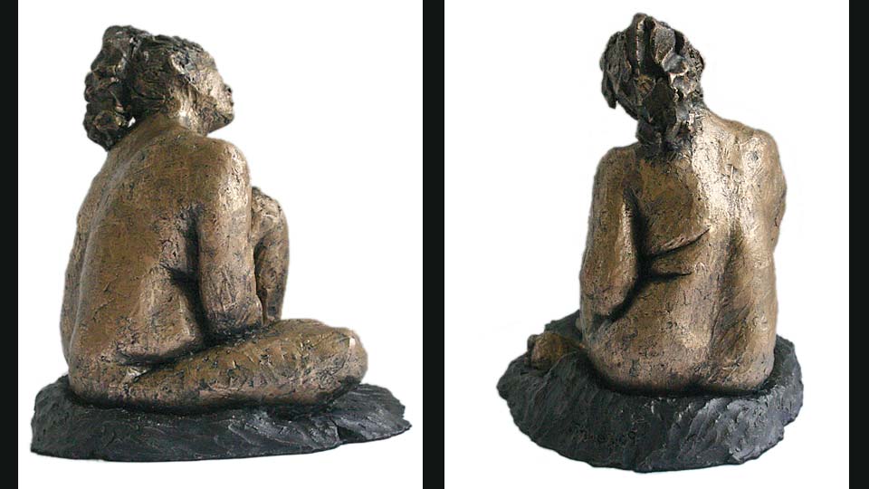 Small clay figure of Gwen seated with her left knee raised.